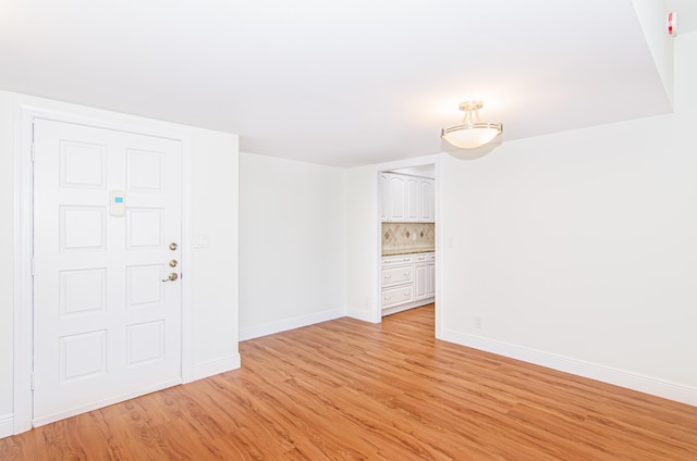 unfurnished room featuring light hardwood / wood-style floors