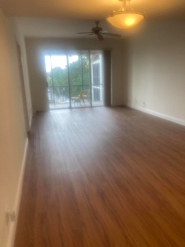 spare room with ceiling fan and dark hardwood / wood-style flooring