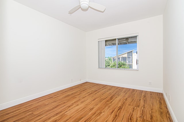 spare room featuring light hardwood / wood-style flooring and ceiling fan