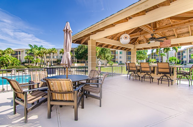 view of patio / terrace with a gazebo, a community pool, and ceiling fan