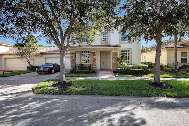 view of front facade featuring a front yard and a garage