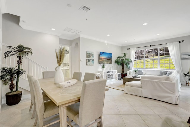 dining space featuring ornamental molding and light tile floors