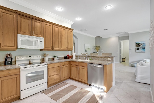 kitchen featuring white appliances, light stone counters, sink, and light tile floors