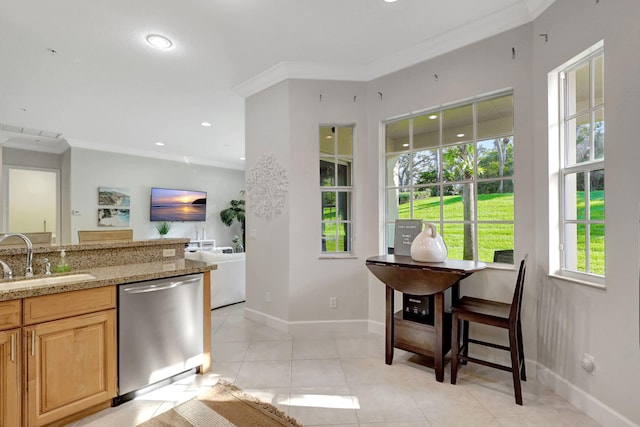 kitchen with stainless steel dishwasher, light tile floors, ornamental molding, sink, and light stone counters