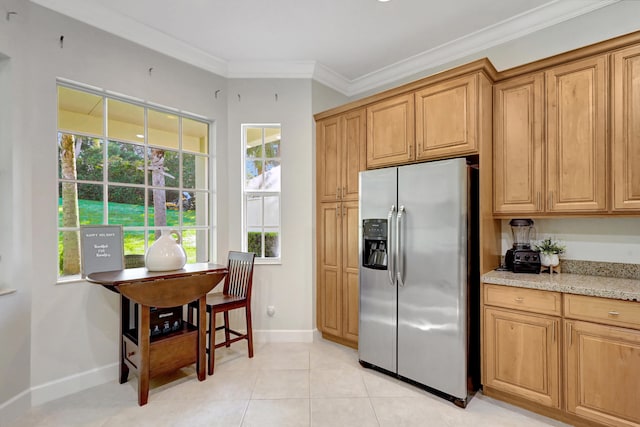 kitchen with light tile floors, light stone countertops, stainless steel refrigerator with ice dispenser, and ornamental molding