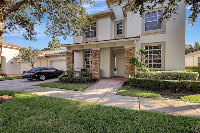 view of front of home featuring a front yard and a garage