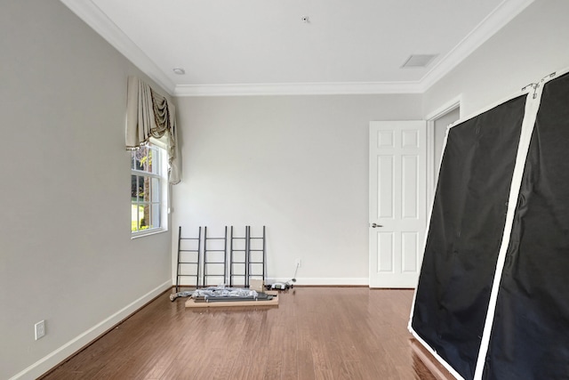 unfurnished room featuring crown molding and dark wood-type flooring