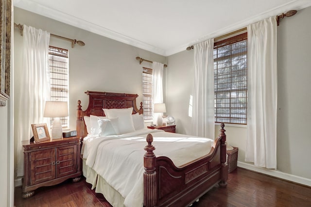 bedroom featuring ornamental molding, multiple windows, and dark hardwood / wood-style flooring