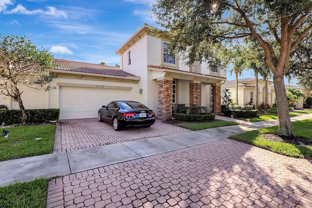 view of front of home featuring a front lawn and a garage