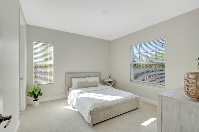 bedroom featuring light colored carpet