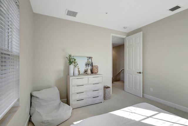 bedroom with light colored carpet