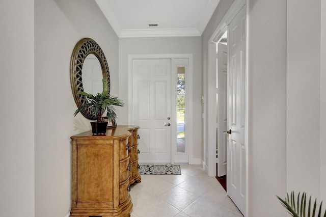 tiled foyer featuring crown molding