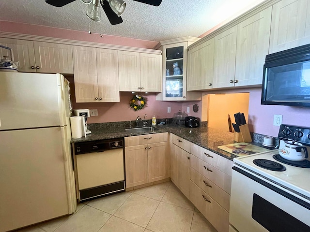 kitchen featuring ceiling fan, white appliances, sink, light tile patterned floors, and a textured ceiling