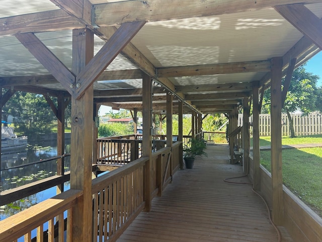 wooden deck featuring a lawn