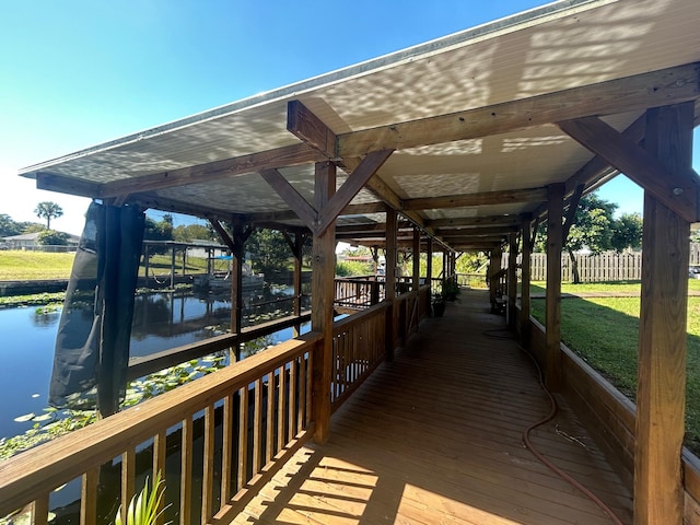 dock area featuring a water view and a yard