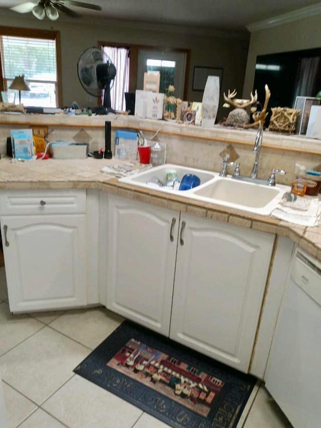 kitchen with light tile floors, white cabinetry, crown molding, and ceiling fan