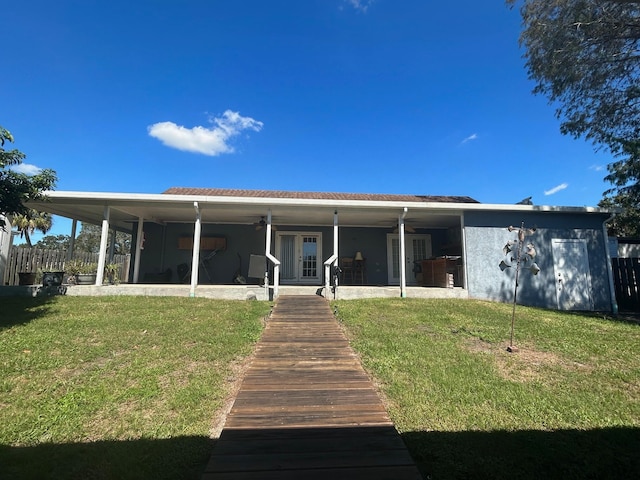 rear view of property with a lawn