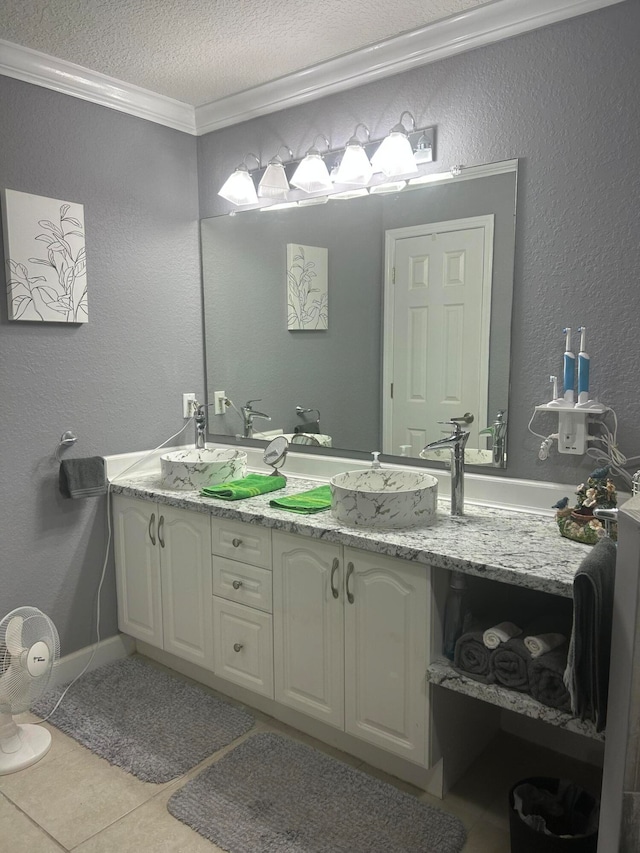 bathroom with crown molding, double vanity, a textured ceiling, and tile flooring