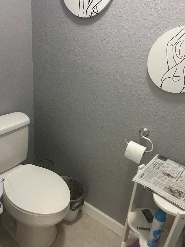 bathroom with toilet and tile flooring