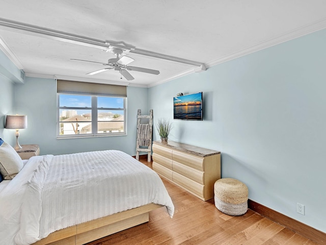 bedroom featuring hardwood / wood-style flooring, ceiling fan, and crown molding