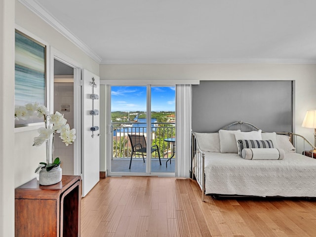 bedroom featuring hardwood / wood-style flooring, crown molding, and access to outside