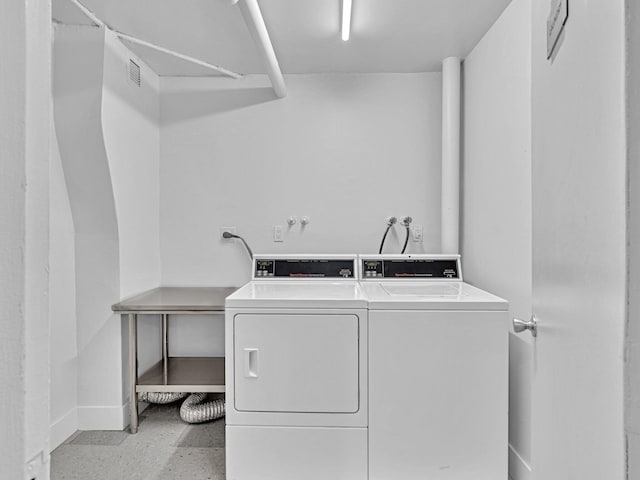 laundry area with washing machine and clothes dryer