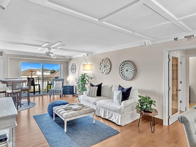 living room featuring ornamental molding, hardwood / wood-style flooring, ceiling fan, and coffered ceiling