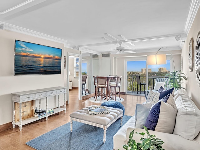 living room featuring ceiling fan, light wood-type flooring, and crown molding