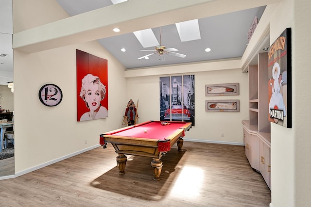 playroom featuring vaulted ceiling with skylight, baseboards, recessed lighting, and wood finished floors