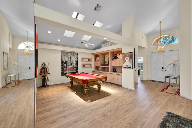 playroom featuring high vaulted ceiling, visible vents, baseboards, and light wood-type flooring