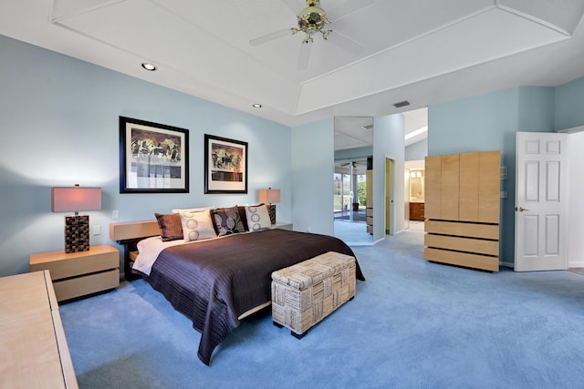 carpeted bedroom with a ceiling fan, visible vents, a raised ceiling, connected bathroom, and recessed lighting