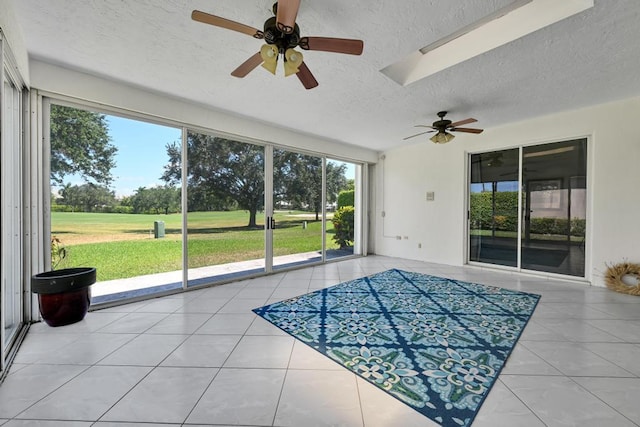 unfurnished sunroom featuring ceiling fan