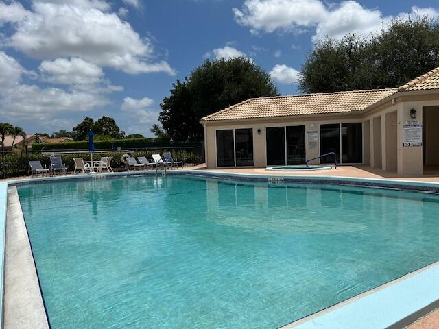 pool with a patio and fence