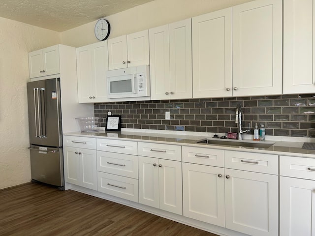 6090 Evian Pl, Boynton Beach, FL 33437 - kitchen featuring high end fridge, a textured wall, a sink, and white microwave