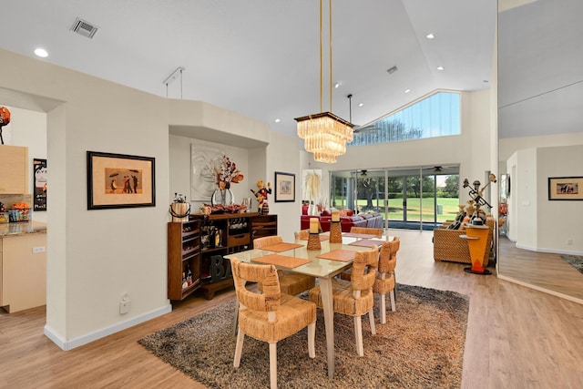 dining space featuring visible vents, baseboards, and light wood-type flooring