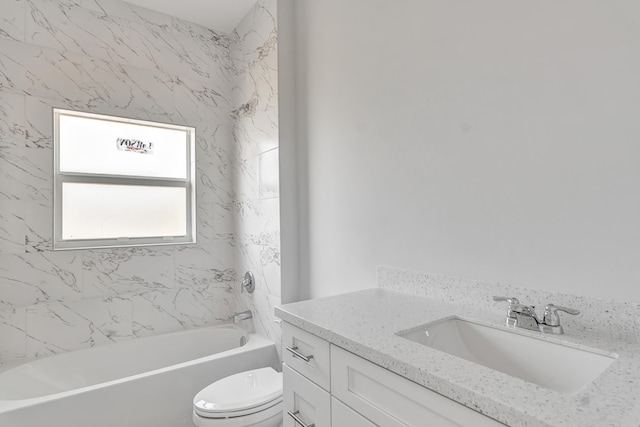 full bathroom with vanity, tiled shower / bath, and toilet