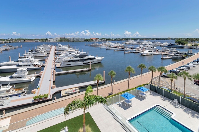 exterior space with a community pool and a water view