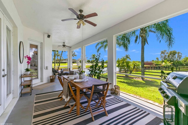 sunroom / solarium with ceiling fan