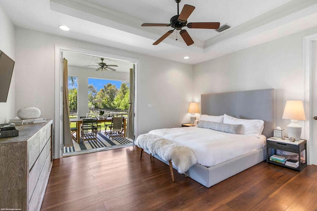 bedroom with ceiling fan, ornamental molding, a tray ceiling, access to outside, and dark hardwood / wood-style floors