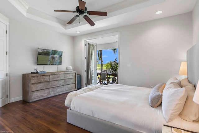 bedroom with ceiling fan, ornamental molding, access to outside, dark wood-type flooring, and a tray ceiling