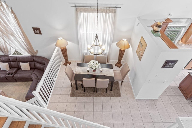 tiled dining space with a notable chandelier