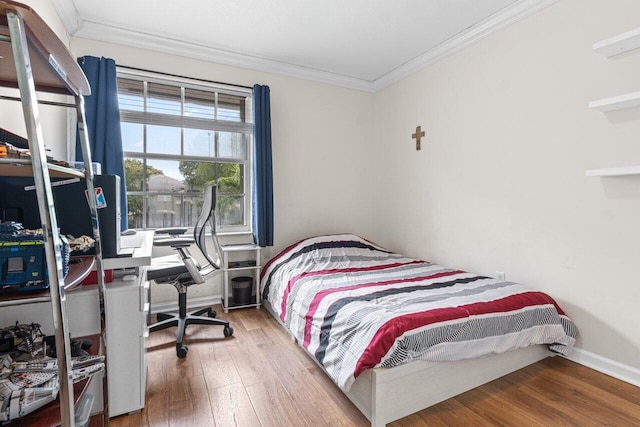 bedroom with ornamental molding and wood-type flooring