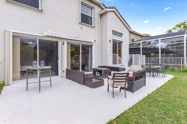 view of patio with an outdoor living space and a lanai