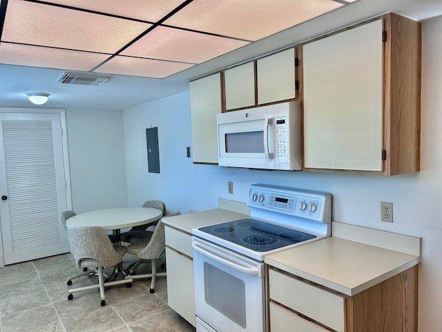 kitchen featuring white appliances and light tile flooring