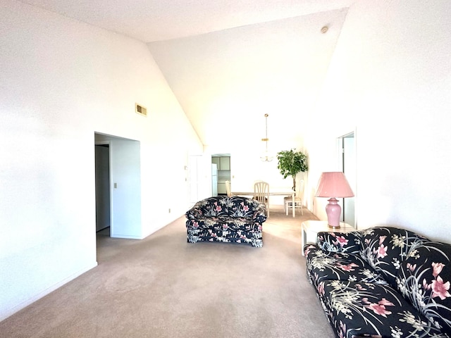 living room with light carpet and high vaulted ceiling