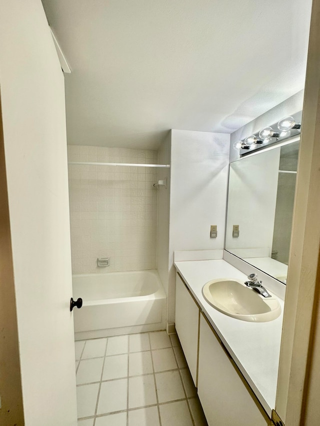 bathroom with vanity with extensive cabinet space, tile flooring, and tiled shower / bath combo