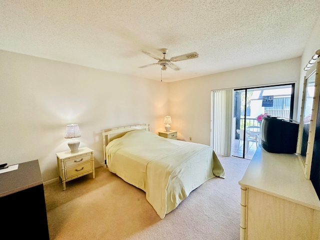 carpeted bedroom with access to exterior, a textured ceiling, and ceiling fan