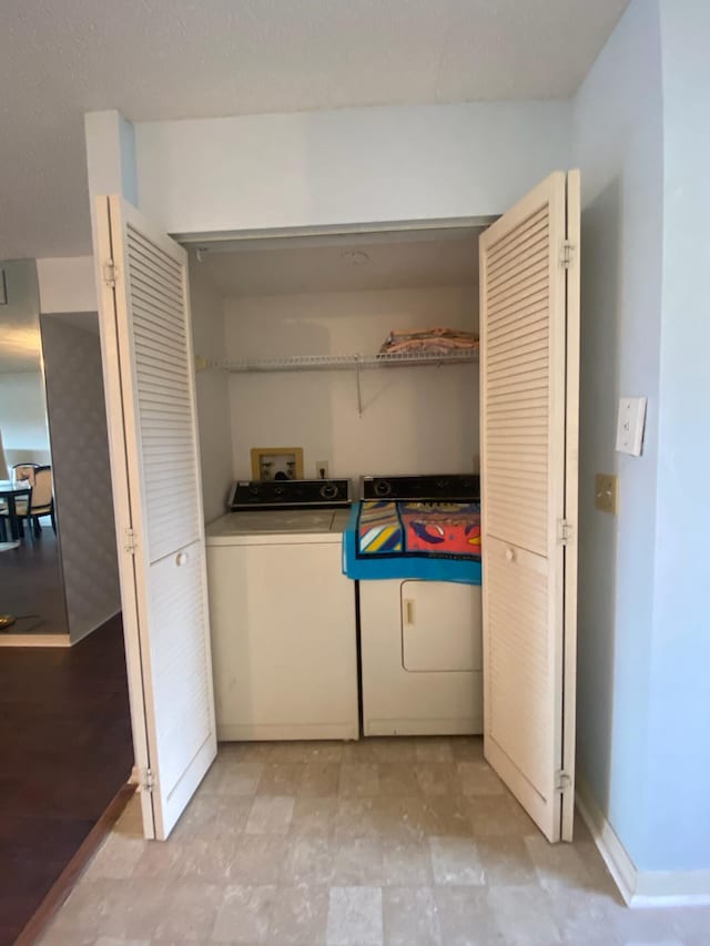 laundry room with washer hookup, light tile floors, and washer and clothes dryer