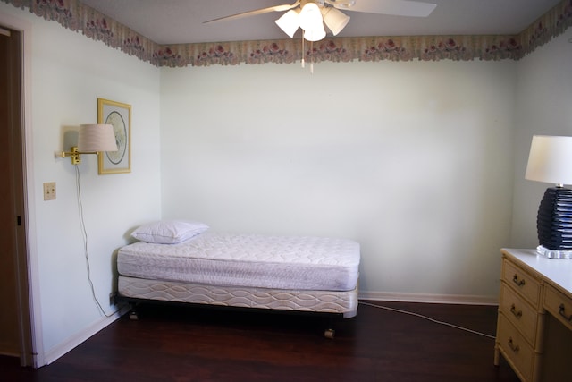 bedroom with ceiling fan and dark wood-type flooring