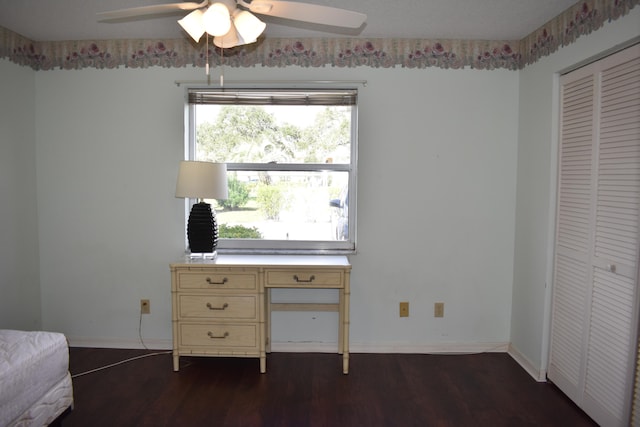 unfurnished office featuring ceiling fan and dark wood-type flooring